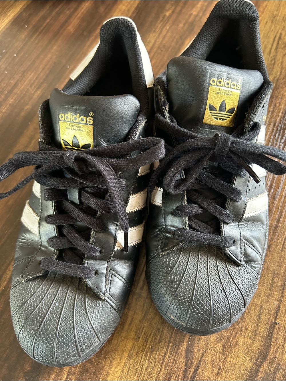 adidas mens Black Sneakers with White Stripes and Gold Logo